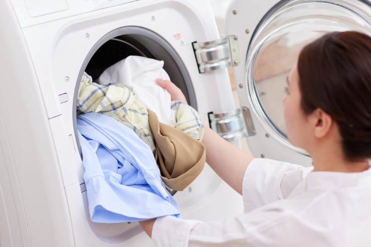 donna che carica lavatrice