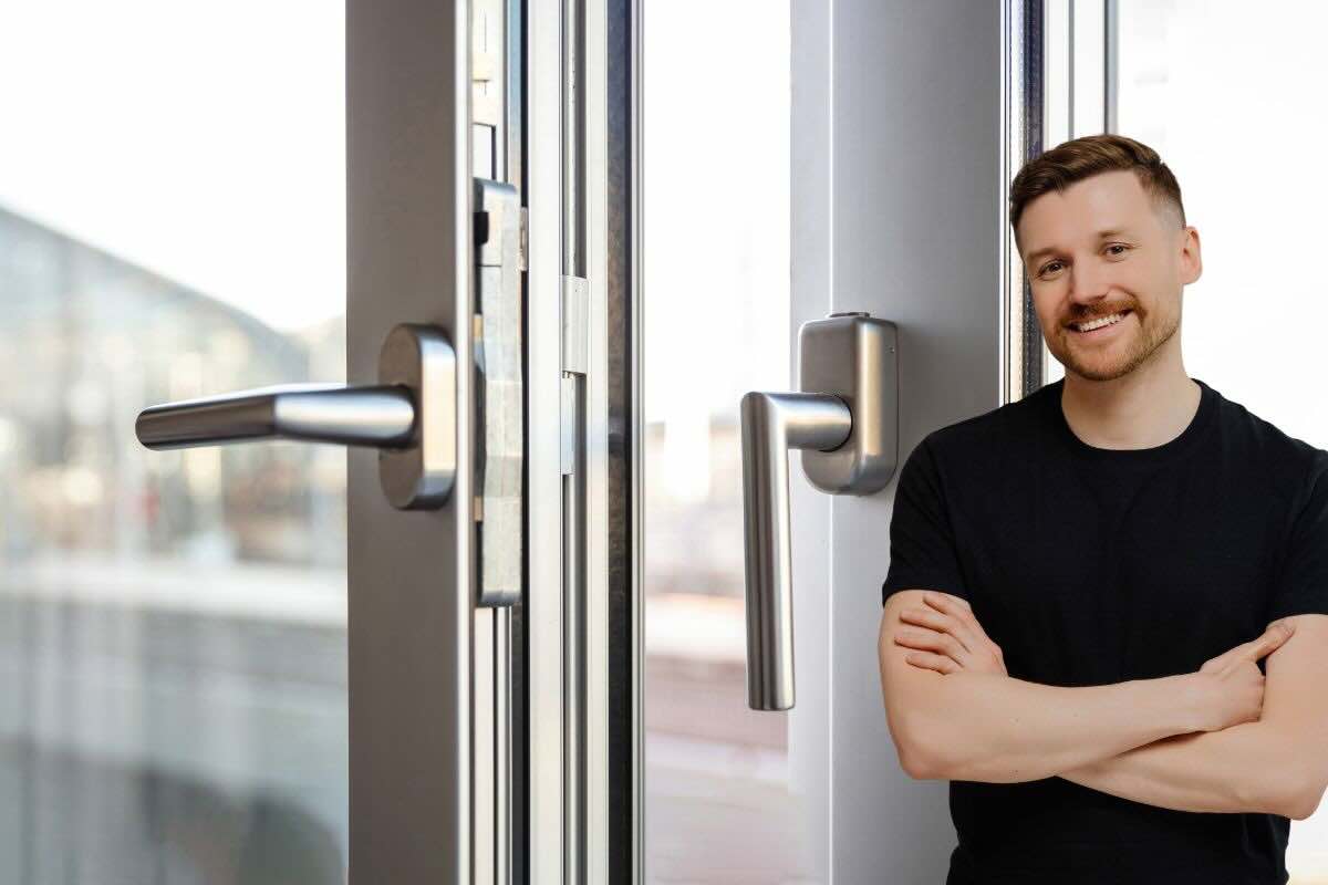 Uomo soddisfatto braccia conserte, finestre aperte